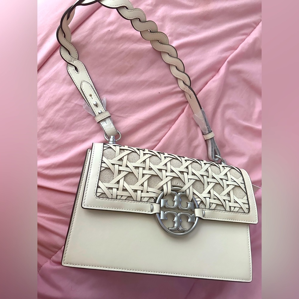 Super cute basket weave shoulder bag by Tory Burch in the color Ivory.